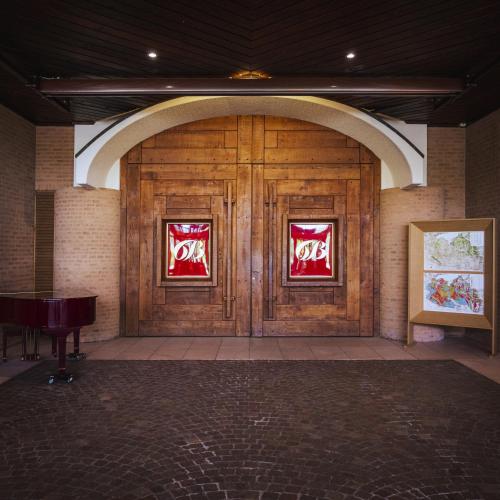 a pair of wooden doors in a building at L'Albereta Relais & Chateaux in Erbusco