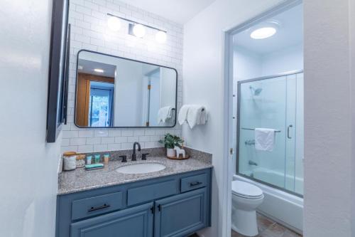 a bathroom with a sink and a toilet and a mirror at #525 Walk to Golf Course, Midtown, Stunning Condo in Mammoth Lakes