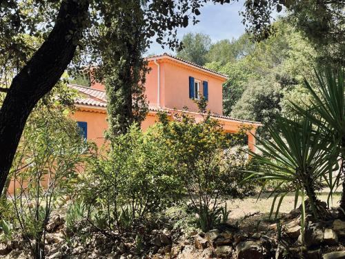 an orange house in the middle of a forest at Villa Les Cyprés in Flayosc