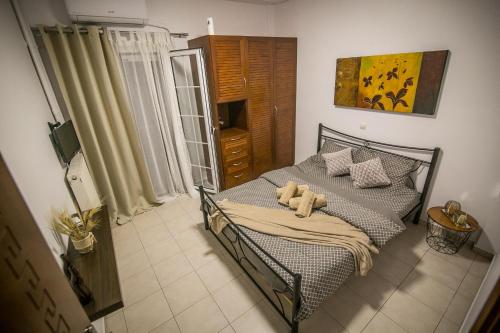 a bedroom with a bed with a teddy bear on it at Central apartment's in Trikala in Tríkala
