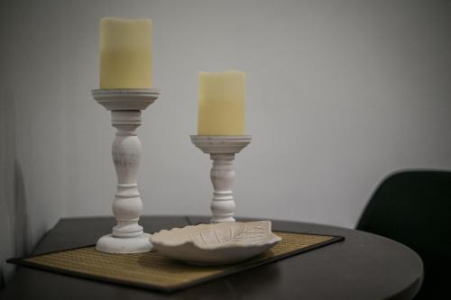 two candles sitting on top of a table at Central apartment's in Trikala in Tríkala