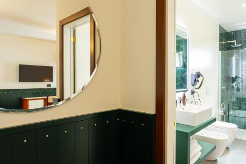 a bathroom with a sink and a mirror at Hotel Ghalà in Galatone