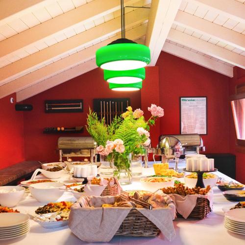 a long table with plates and food on it at L'Albereta Relais & Chateaux in Erbusco