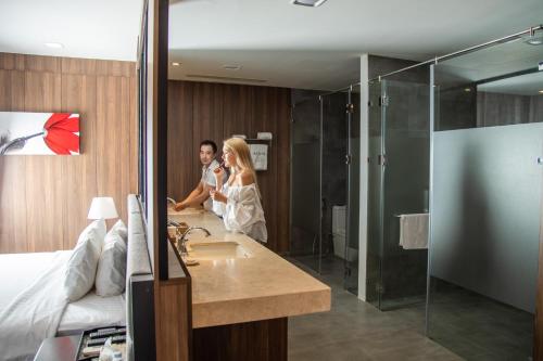 a man and woman standing in a hotel bathroom at Nha Trang Oceanfront Luxury Villa Anh Nguyen in Nha Trang