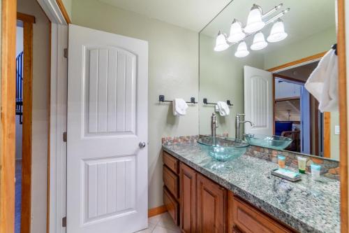 a bathroom with two sinks and a large mirror at #359 - Mountain Condo, Walk to Shops with Pool, Spa, & Game Room in Mammoth Lakes