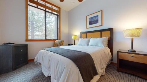 a bedroom with a large bed and a window at #550 Village, Walk to Gondola 3BD, 3BATH with Spa in Mammoth Lakes