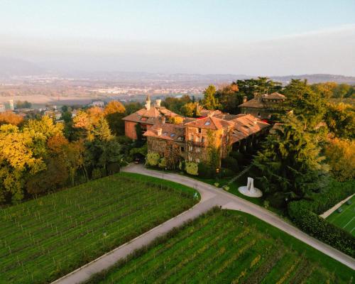an aerial view of a large house with a road at L'Albereta Relais & Chateaux in Erbusco