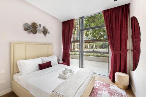 a bedroom with a bed and a large window at City Walk, Al Wasl, Jumeirah - Mint Stay in Dubai