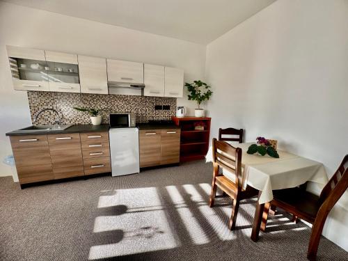 a kitchen with a table and a white refrigerator at Pod Klíčem in Svor
