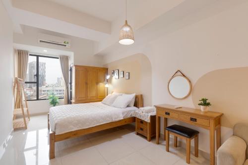 a bedroom with a bed and a desk and a mirror at Saigon Authentic Apartments - Amazing Infinity Pool and FREE Daily Breakfast Voucher, Walking Tour and 4G SIM card for 3 nights booking in Ho Chi Minh City