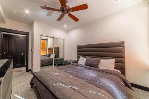 a bedroom with a bed and a ceiling fan at #544- Luxury Village 3BR - Spa, Pool, & Walk to Gondola in Mammoth Lakes