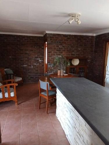 a kitchen with a counter and a brick wall at Raapfontein Self-catering in Hanover