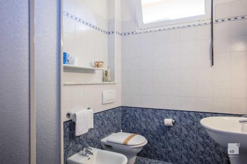 a bathroom with a toilet and a sink at Hotel Venezia in Marina di Pietrasanta