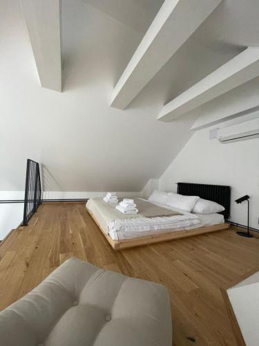 a white room with two beds and a couch at Resort po.spolu in Mokrovraty