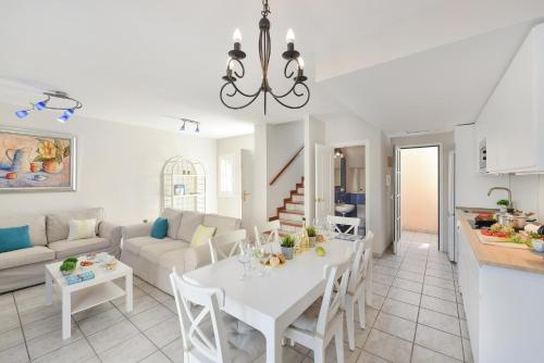 a kitchen and living room with a white table and chairs at Bungalow Pasito Blanco Marina Port 4 by VillaGranCanaria in Pasito Blanco