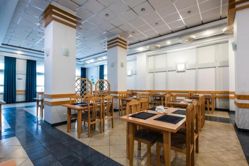 a dining room with wooden tables and chairs at Rewita Międzyzdroje - Grunwald in Międzyzdroje