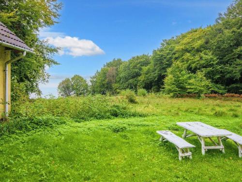 een picknicktafel en een bank in een veld bij 5 person holiday home in Skanderborg in Skanderborg