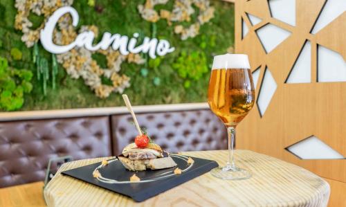 a plate of food and a glass of beer on a table at Checkin Camino de Granada in Granada