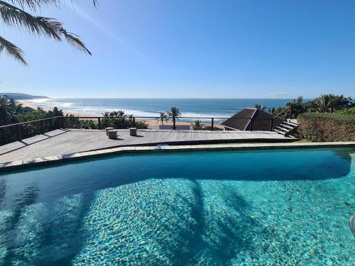 a swimming pool with a view of the beach at THE ARK in Zinkwazi Beach in Zinkwazi Beach