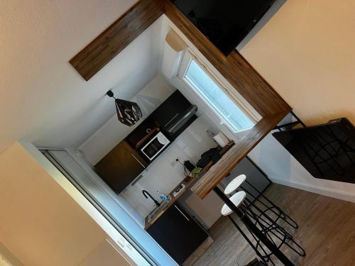 an overhead view of a small kitchen with two chairs at Secrète loft in Aucamville