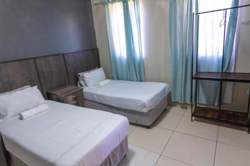 מיטה או מיטות בחדר ב-Latona Guest House