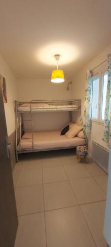 two bunk beds in a room with a light at Apartment L'Aquarius in Villeneuve-le-Roi