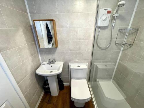 a bathroom with a toilet and a sink and a shower at Charming Terrace Home, Nantwich -Near train station & Town in Nantwich