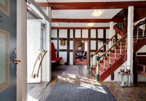 a hallway with a staircase in a house at Hotel Ringkøbing in Ringkøbing