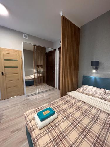 a bedroom with a bed with a towel on it at BoleslaviaApartments - Apartament Simon 2, Center, air conditioning in Bolesławiec