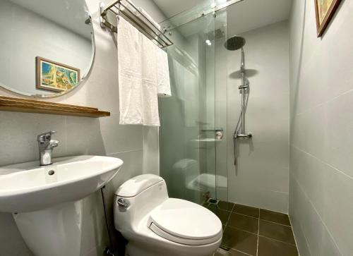 a bathroom with a toilet and a sink and a shower at 8 minutes walking to Nguyen Hue, Fast Wifi, check-in 24/7 in Ho Chi Minh City