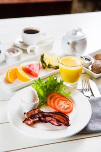 a white plate of food on a table with food at Ruissalo Spa Hotel in Turku