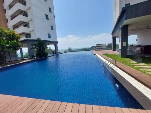 a large swimming pool next to a building at Full Seaview 3BR 3BD Duplex Apartment 房间全面向海景-3房 3卫 复式公寓 in Port Dickson