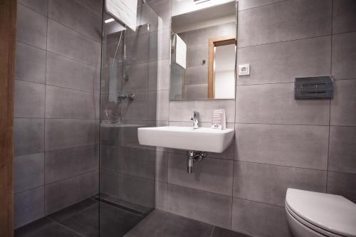 a bathroom with a sink and a toilet at Resort Hotel Bispingen Superior in Bispingen