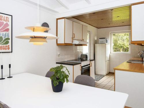 a kitchen with a white table and a refrigerator at 6 person holiday home in Haderslev in Haderslev