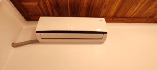 a white printer on a wall in a room at Villa KiengKham晶康民宿 in Luang Prabang