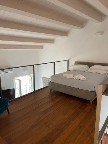 a bedroom with a bed and a wooden floor at B&B Aganita in Ancona