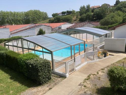 an image of a glass house with a swimming pool at Erreka pays basque in Hasparren