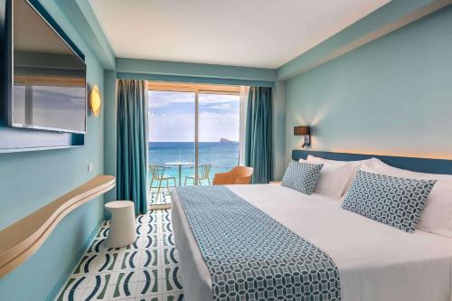 a bedroom with a bed with a view of the ocean at Barceló Benidorm Beach - Adults Recommended in Benidorm