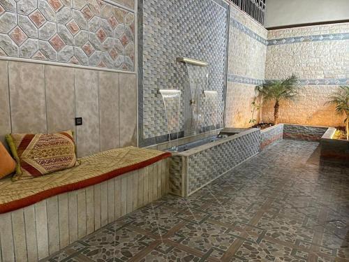 a bathroom with a tub and a shower with tiles at Apartment in Larache Marokko in Larache