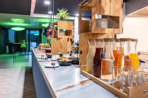 a kitchen with a counter with many glass bottles at voco Brussels City North by IHG in Vilvoorde