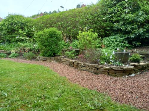 a garden with a stone path and plants at The Side - Hexham in Hexham