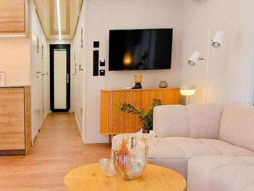 een woonkamer met een witte bank en een tafel bij Dom na wodzie LaMare Modern 14 in Bydgoszcz