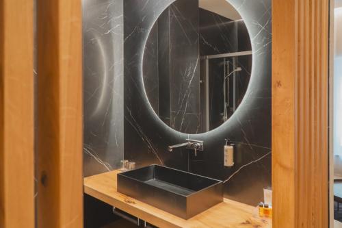 a bathroom with a black sink and a mirror at Zenit Convento San Martin in San Sebastián
