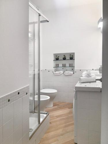 a white bathroom with a toilet and a sink at MARCONA 1 - City Centre Apt with Terrace in Milan