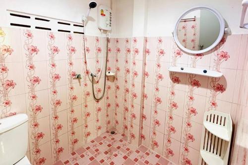 a bathroom with a shower with pink flowers on the wall at Lamsai AC Sea House in Ko Yao Noi