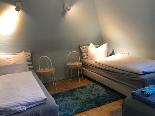 a bedroom with two beds and two night stands at Blaues Zimmer, -keine Wohnung, keine Küche-mit grossem Balkon, Bad ist ein Traum, nur 50 Schritte zum Radweg am Main in Mainstockheim