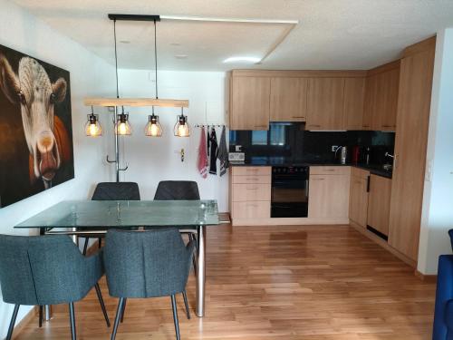 a kitchen and dining room with a table and chairs at Camenzind in Gersau
