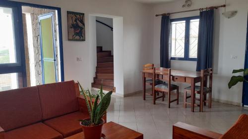 a living room with a couch and a table at Casa Torre in Palmeira