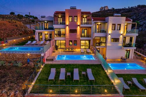 an aerial view of a house with a swimming pool at Villa Mari Chania, with private ecologic pool and amazing view! in Chania