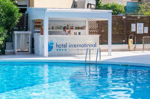 a hotel international sign next to a swimming pool at International Hotel & Suite in San Benedetto del Tronto